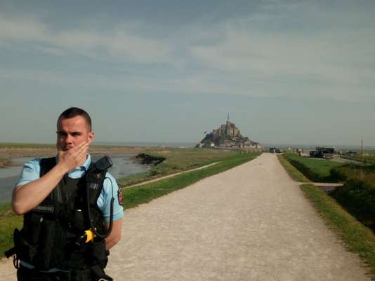 French gendarme is seen near Mont Saint-Michel as it was closed and evacuated after a man threatened he installed a bomb on the island