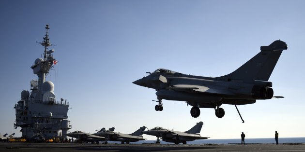 A French Rafale fighter jet prepares to land on the flight deck of the Charles-de-Gaulle aircraft carrier operating in the eastern Mediterranean Sea