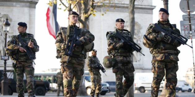 French soldiers patrol in front of the Arc de Triomphe on the Champs Elysees avenue in Paris, France