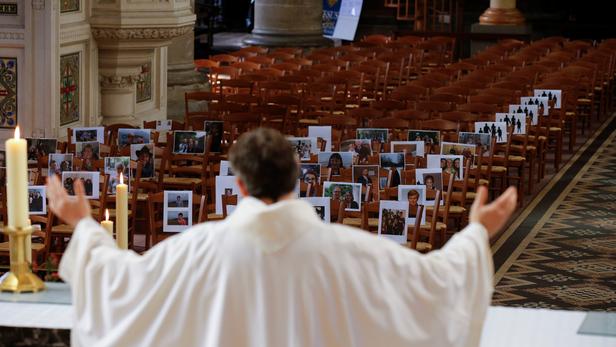 Priest Xavier Lemble holds the Easter mass with photos of believers during the coronavirus disease (COVID-19) lockdown in Bethune